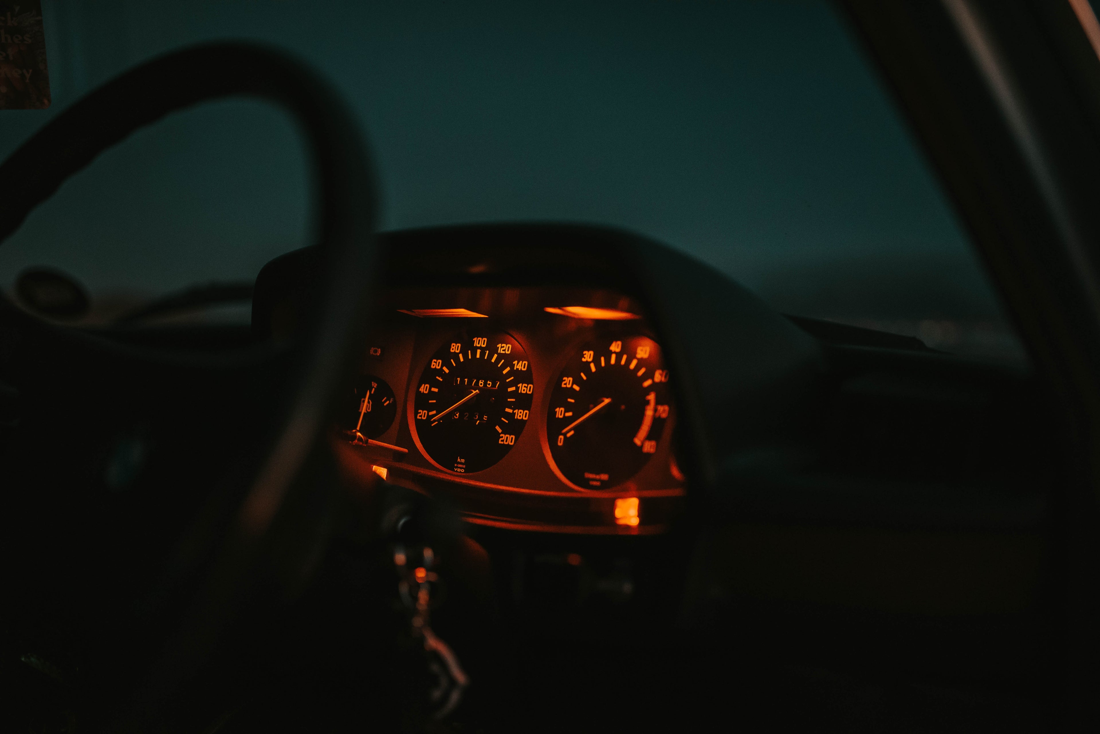 car-dashboard-lit-red-with-steering-wheel-night